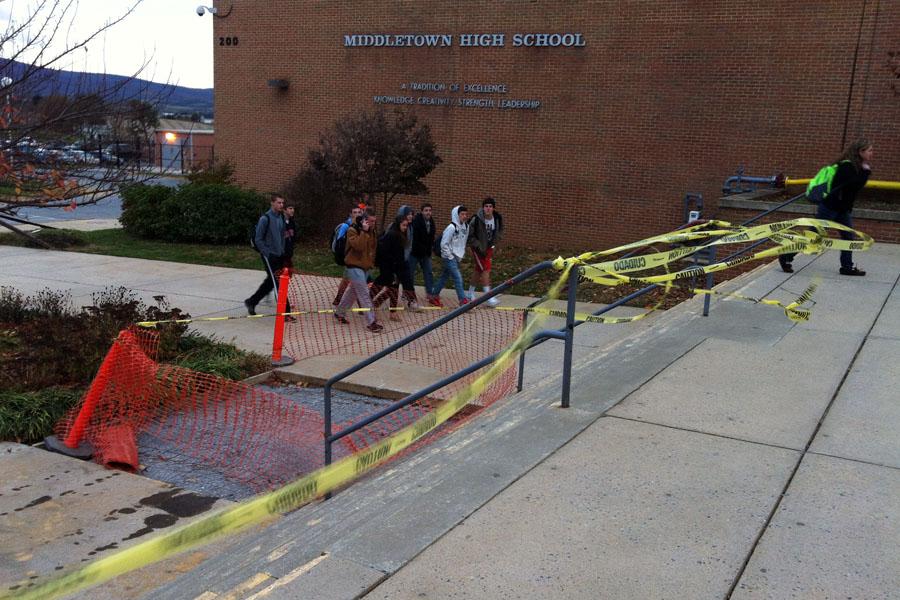 Crumbling sidewalks and steps await repair as Middletown High School students walk around them on their way to school on Nov. 12. The sidewalks were beginning to crack and fall apart and in recent weeks had been blocked off by orange traffic cones. The timeline on when the sidewalks and steps will be completely repaired has not yet been determined. 