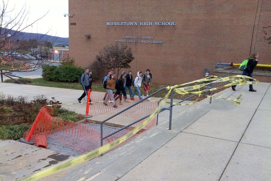 Crumbling sidewalks and steps await repair as Middletown High School walk around them on their way into school on Nov. 12. The sidewalks beginning to crack and fall apart and in recent weeks had been blocked off by orange traffic cones. The timeline on when the sidewalk and steps will be completely repaired has not yet been determined.
