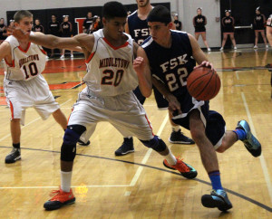 Middletown junior Cedric Ayenu (#20) guards an FSK defender during the Knights 50-49 win over the Eagles.