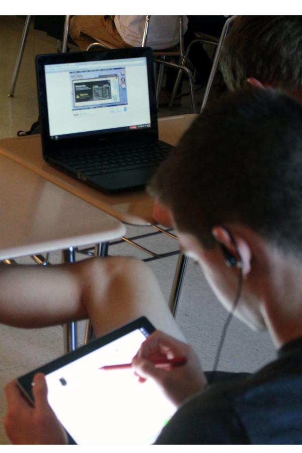 MHS students use their devices in class to work on a project. 