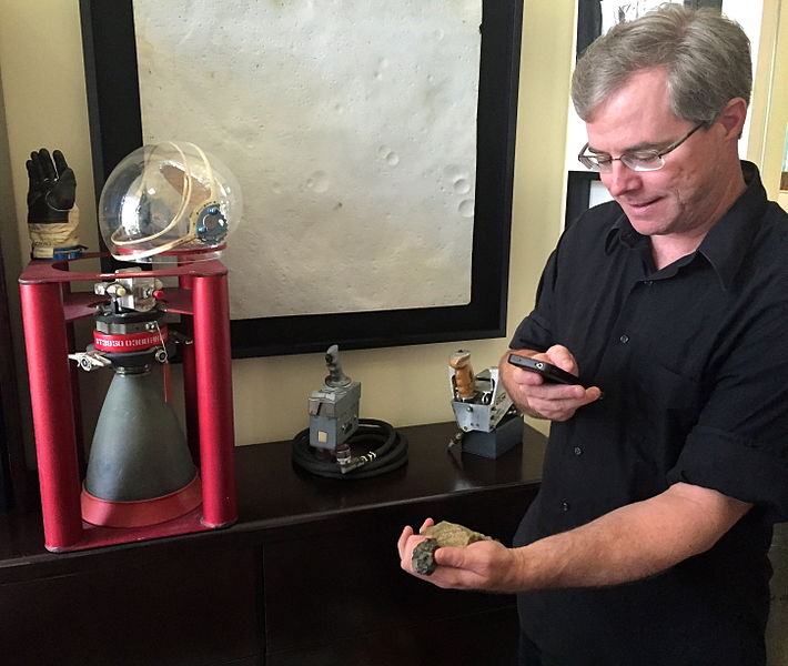 Andy Weir, author of The Martian holds a Mars rock.