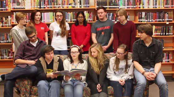 MHS students read a book aloud in the library for Read Aloud Day.