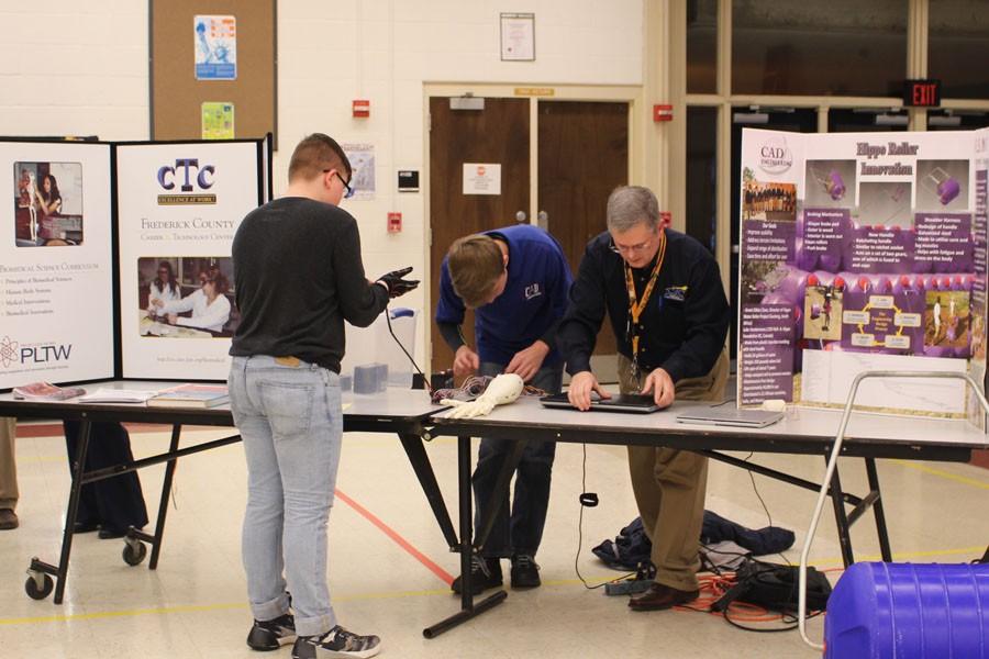 A student visits a class  booth on registration night. 