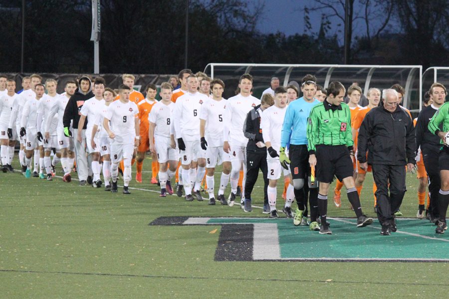 Right before the big game, the boys varsity team lines up and waits to get started. -Photo By Jack Sullivan 