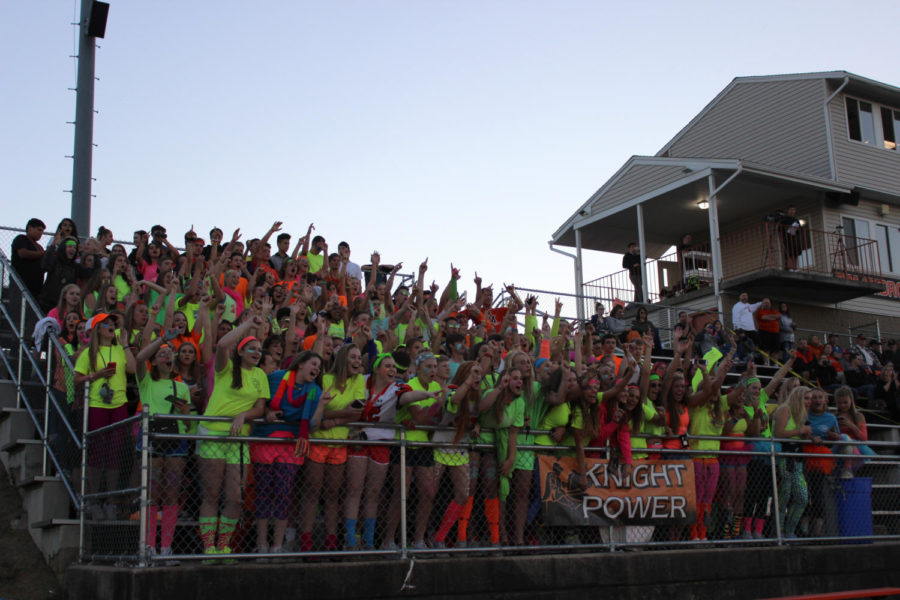 The+student+section+at+MHS+is+electric+on+neon+night.