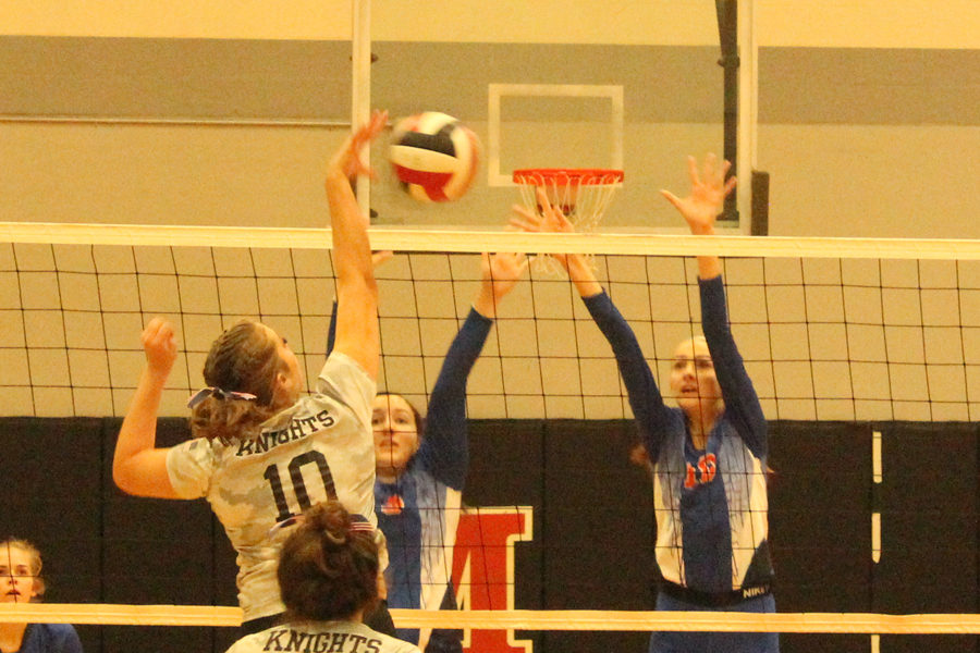 Sydney Wilbur tips the ball right over the net against BHS.