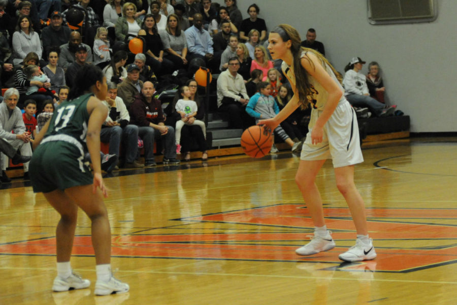 MHS player Saylor Poffenbarger dribbles the ball down the court. 