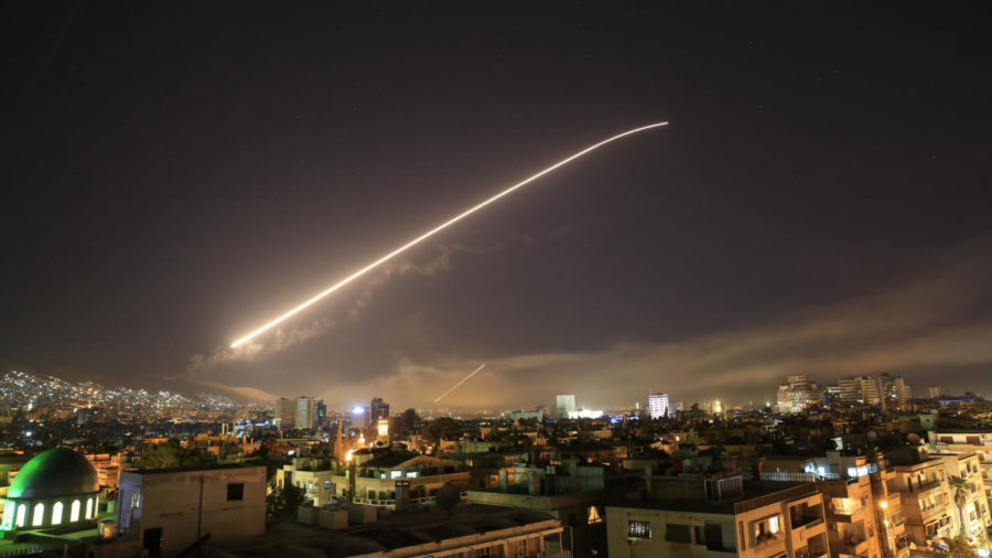 The Damascus sky lights up with missile fire as a U.S.-led coalition launches an attack early Saturday, targeting different parts of the Syrian capital.